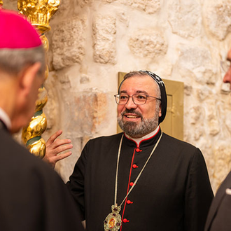 Archbishop Mor Anthimos Jack Yakoub, Syrian Orthodox patriarchal vicar for Jerusalem, Jordan and the Holy Land, gives the delegation a tour of St. Mark Monastery in Jerusalem after their meeting Sept. 3. (Photo by George Jaraiseh)