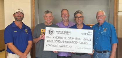 Knights from Fort Bend Council 2801 in Rosenberg, Texas, present a check for $3,600 to Grand Knight Michael Lorino (second from left) of Father Kemper Council 6409 in Kerrville to support flood relief efforts. The funds came from Council 2801’s general fund and donations from individual Knights.