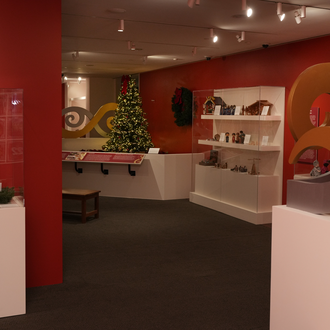 Photo of a museum gallery with Nativity scenes on exhibit.