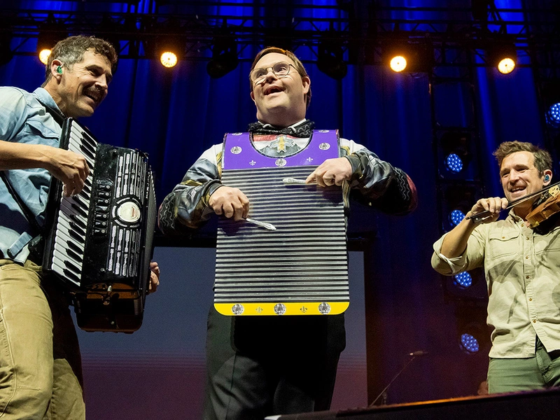 Danylo Fedoryka (left) and his brother Alexander, both members of John Carrell Jenkins Council 7771 in Front Royal, Va., and founding members of the folk band Scythian, invite Eric Latcheran, a member of Family of Man Council 7566 in Reston, Va., to play the washboard during their performance at Life Fest at EagleBank Arena in Fairfax, Va., Jan. 24. 