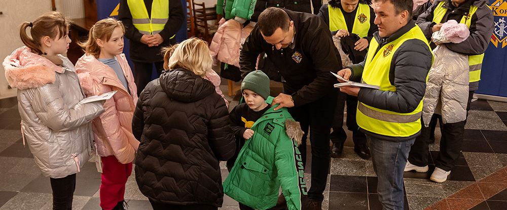 Children trying on winter coats