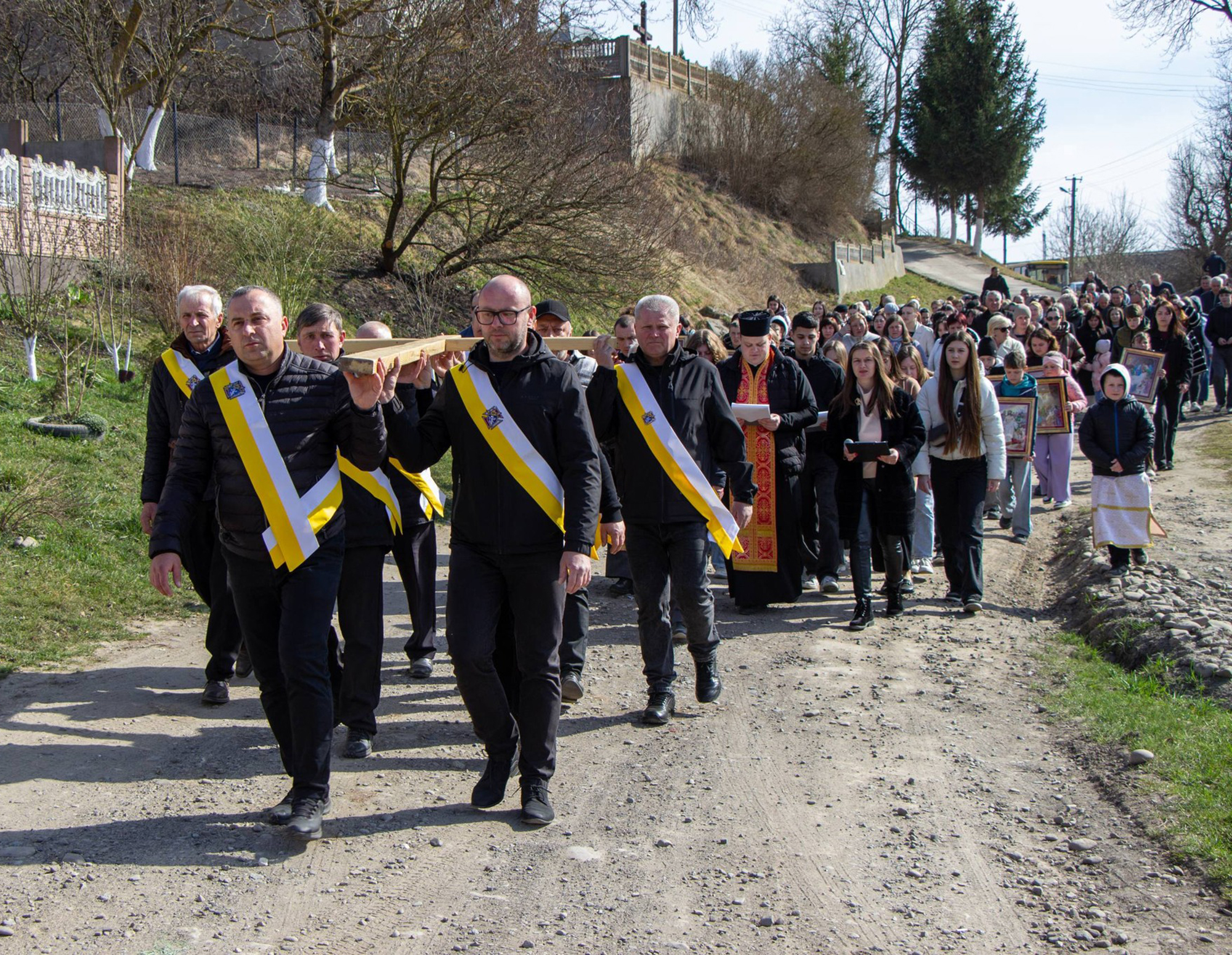 Polish Knights carry the cross as they lead a Way of the Cross procession from Obel&rsquo;nytsya to Konyushky.