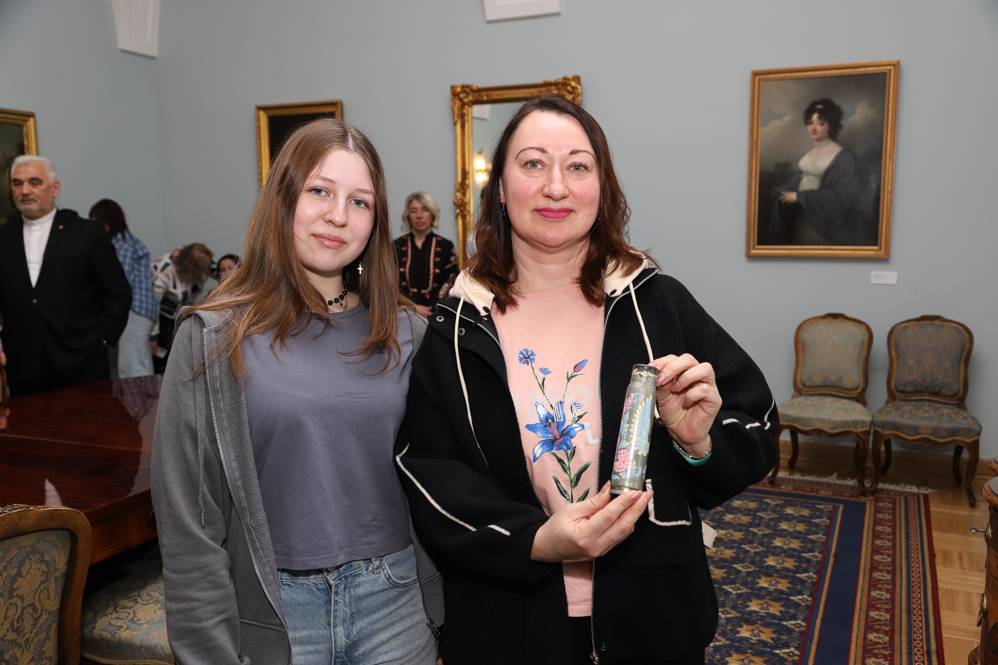 Participants in the Pilgrimage of Hope hold a shell casing recovered from a battlefield in Ukraine and painted by hand.
