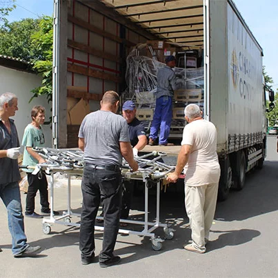Men unload medical supplies from a Knights of Columbus Charity Convoy at a hospital in Izmail, Ukraine, on Aug. 6.