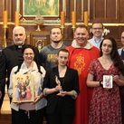 Members of the Knights of Columbus Kraków office in front of the altar containing the remains of the Ulma family at St. Dorothy Church.