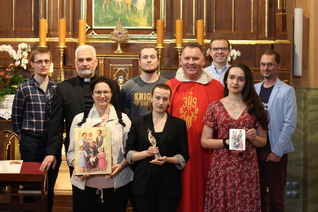 Members of the Knights of Columbus Kraków office in front of the altar containing the remains of the Ulma family at St. Dorothy Church.
