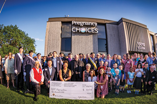  Knights, family members and staff from Pregnancy Choices in Apple Valley after a ceremony to bless the new ultrasound machine the Knights placed at the center