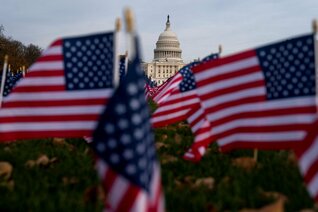Flags wave in front of the United States Capitol building in Washington, D.C.