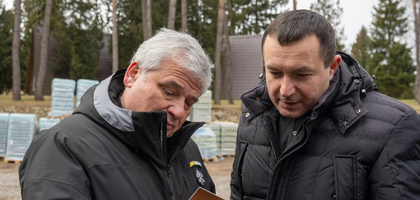 Cardinal Konrad Krajewski and then-State Deputy Yuriy Maletskiy examine a holy card of Blessed Michael McGivney.