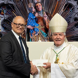 Deputy Supreme Director Arthur Peters, past state deputy of Ontario, presents the Order’s annual donation to the Canadian Conference of Catholic Bishops to its president, Bishop William T. McGrattan of Calgary, at the conclusion of the Aug. 7 Mass.
