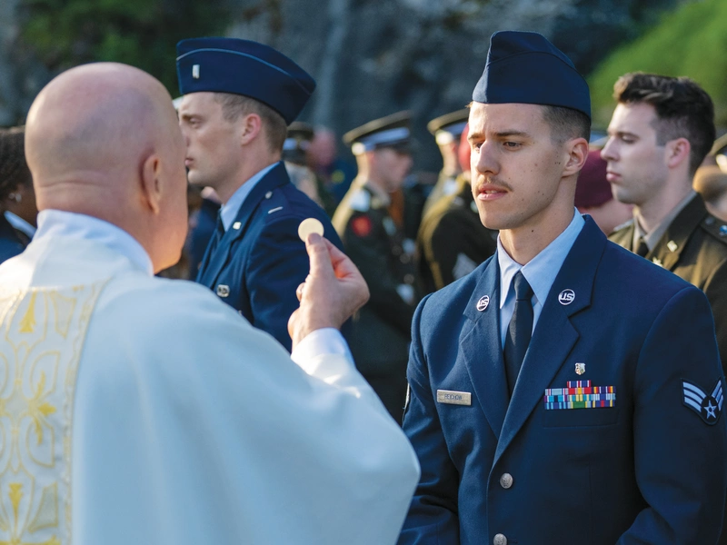 U.S. Senior Airman Caleb Reichow receives the Eucharist