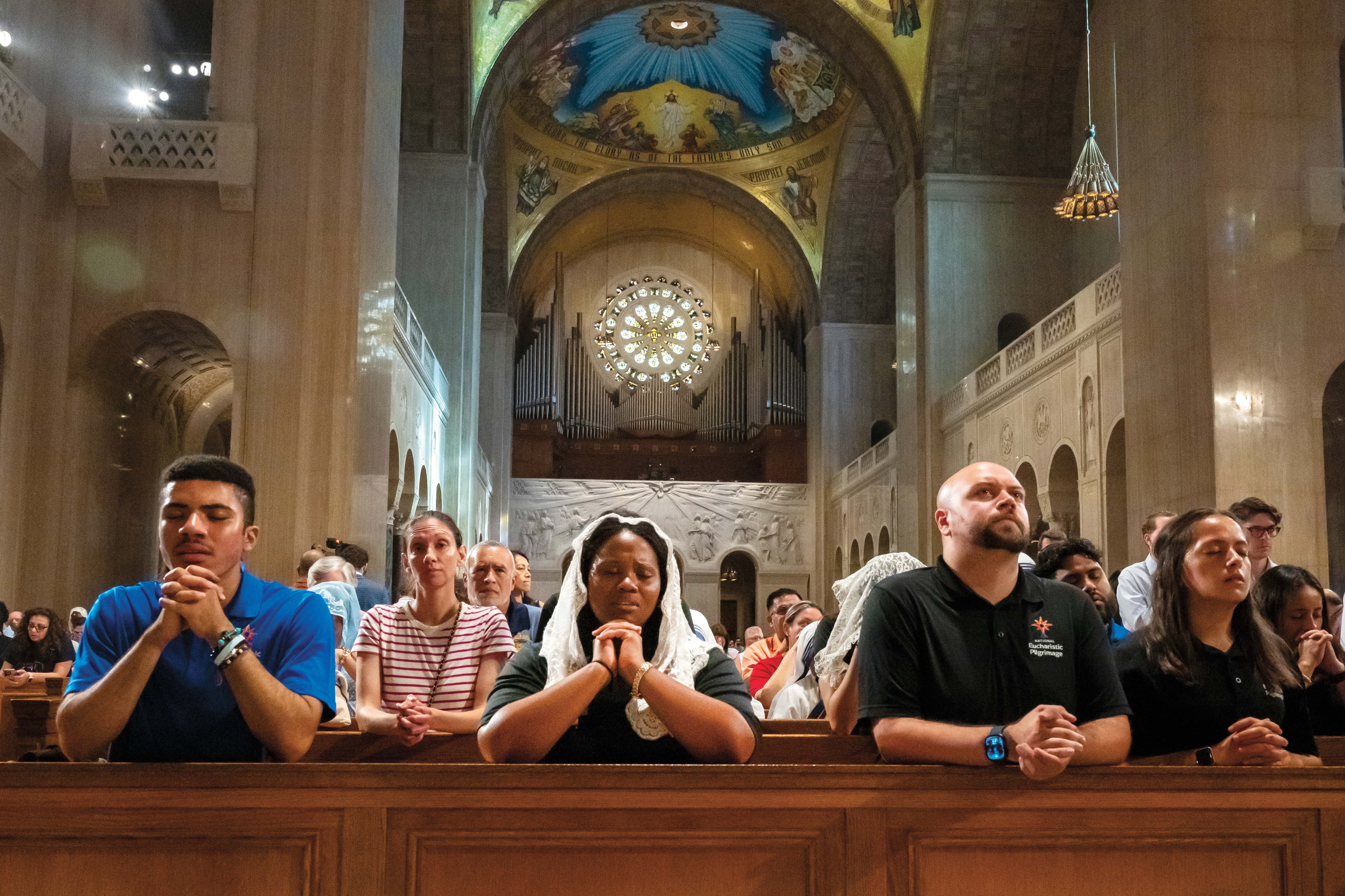 Hundreds of Catholics pray during a Corpus Christi vigil Mass at the Basilica of the National Shrine of the Immaculate Conception in Washington, D.C.