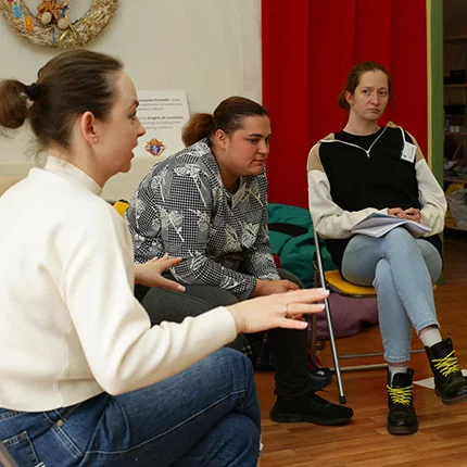 A psychologist working with STEP-IN medical organization conducts a group therapy session with several widows in Fastiv in April.