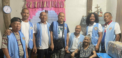 Members of Fatima Council 5672 in Carmen, Visayas, gather around Marcela Anunciado after presenting her with a new wheelchair.