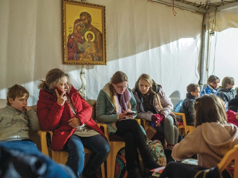 Ukrainian women and children rest at a K of C tent in Hrebenne, Poland.