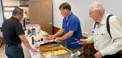 Jerry Boyer (center) and Jim Toth, members of Father Pierre Desmet Council 9756 in Pinedale, Wyo., serve food during the council’s annual Mother’s Day pancake breakfast at Our Lady of Peace Catholic Church.