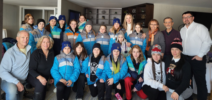 Knights and family members from St. Nicholas Byzantine Ukrainian Council 7659 in Calgary, Alberta, gather with members of the Ukrainian Wings youth hockey team after presenting them with winter jackets donated through the Knights of Columbus Coats for Kids program.