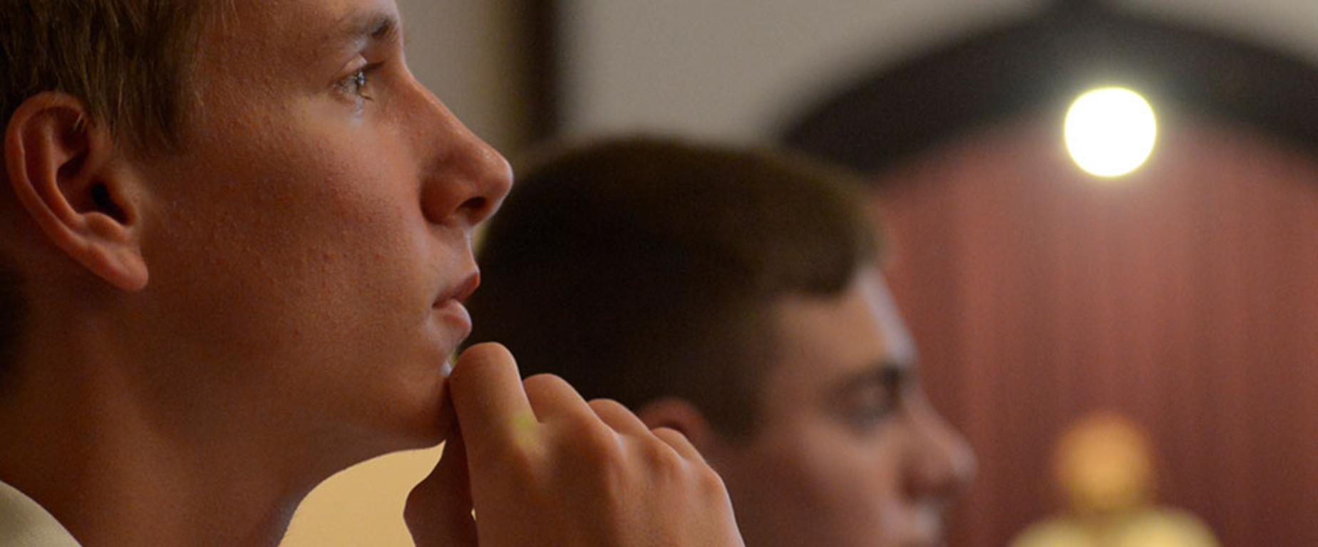 Youth engaged in a prayer for spiritual-reflection.