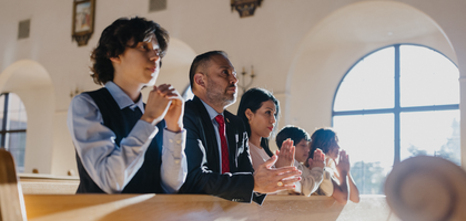 A family praying together at church.