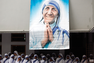 Missionaries of Charity sisters gather under a picture of Blessed Teresa in Calcutta