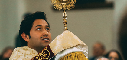 Priest leads a eucharistic procession