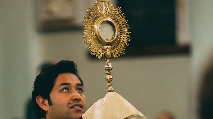 Priest leads a eucharistic procession