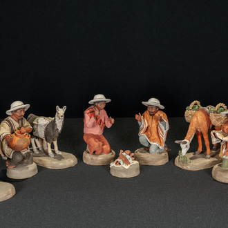Nativity scene from Argentina made of painted clay and depicting the Holy Family, three Magi, and three llamas.