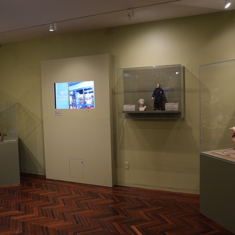 Photo of a museum gallery with Nativity scenes on exhibit.