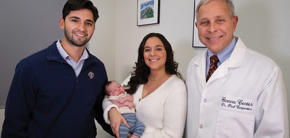 Franco and Katelyn Pellicciotta and their new baby visit with Dr. Paul Carpentier, director of the Gianna Center in Babylon, N.Y. (Photo by Jeffrey Bruno)