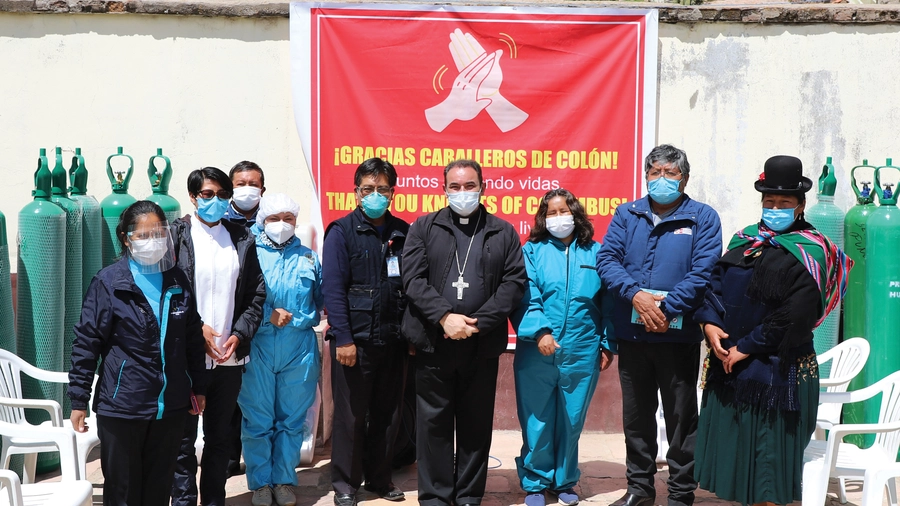 Bishop Giovanni Cefai of the Territorial Prelature of Santiago Apóstol de Huancané in Peru (center) stands with health care workers from the province of Puno, Feb. 26, after blessing oxygen cylinders donated by the Knights of Columbus