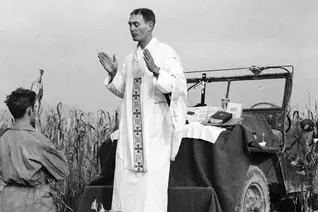 Using the hood of his jeep as an altar, U.S. Army chaplain Father Emil Kapaun celebrates Mass in Korea