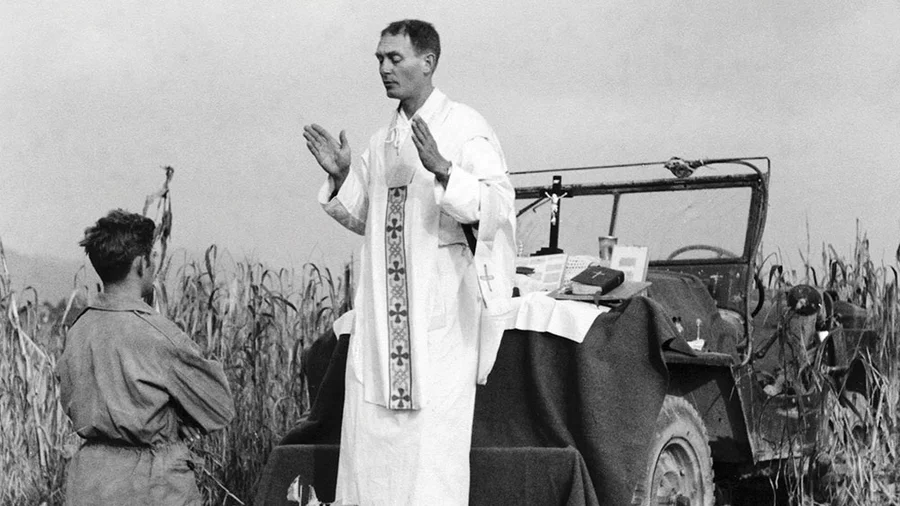 Using the hood of his jeep as an altar, U.S. Army chaplain Father Emil Kapaun celebrates Mass in Korea