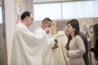 Communion is distributed at a Mass celebrated in the Redemptor Hominis Church 