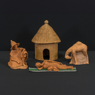Photo of a clay Nativity scene depicting Mary and the Christ Child lying down with Joseph and a camel looking on. 