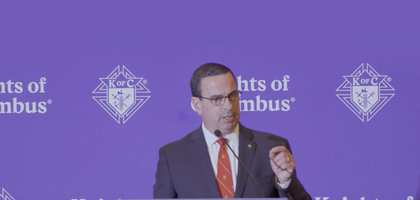 Damien O'Conner gives a speech at the 2025 State Deputies meeting