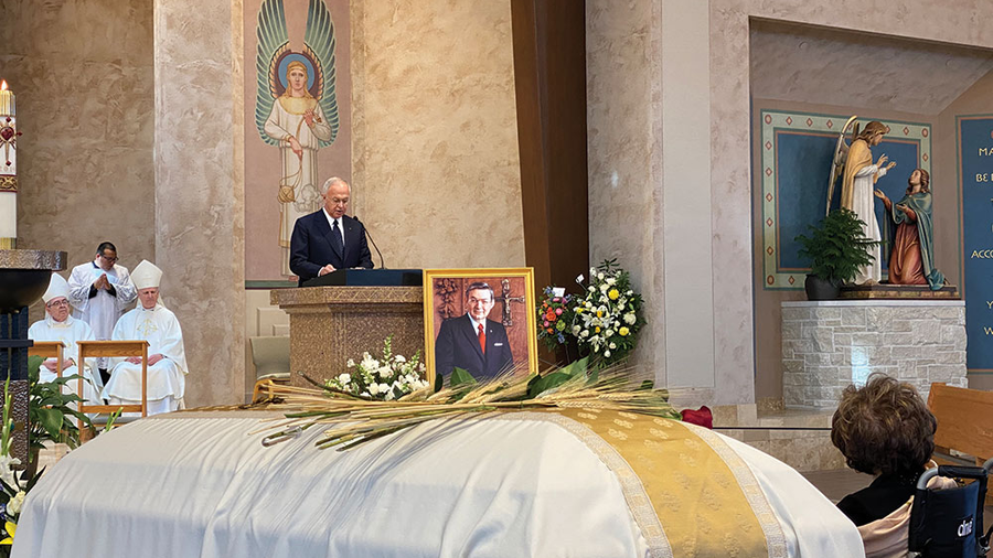 Supreme Knight Carl Anderson delivers the eulogy for his predecessor at the Church of the Nativity in Leawood, Kan., on Feb. 22. Ann Dechant (right) is seated beside her husband’s coffin.