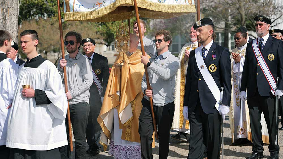 College Knights carry the canopy over the Blessed Sacrament and Fourth Degree Knights provide an honor guard as Bishop Edward Rice leads a Eucharistic procession through Cape Girardeau, Mo., March 17. It was the final day of an 845-mile Eucharistic pilgrimage across the Diocese of Springfield-Cape Girardeau. (Photo by Castletown Media)
