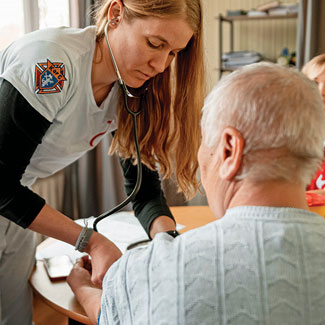 Dr. Doris Schulz, a physician from Argentina, treats a patient at the STEP-IN clinic in Dnipro, Ukraine, April 25.