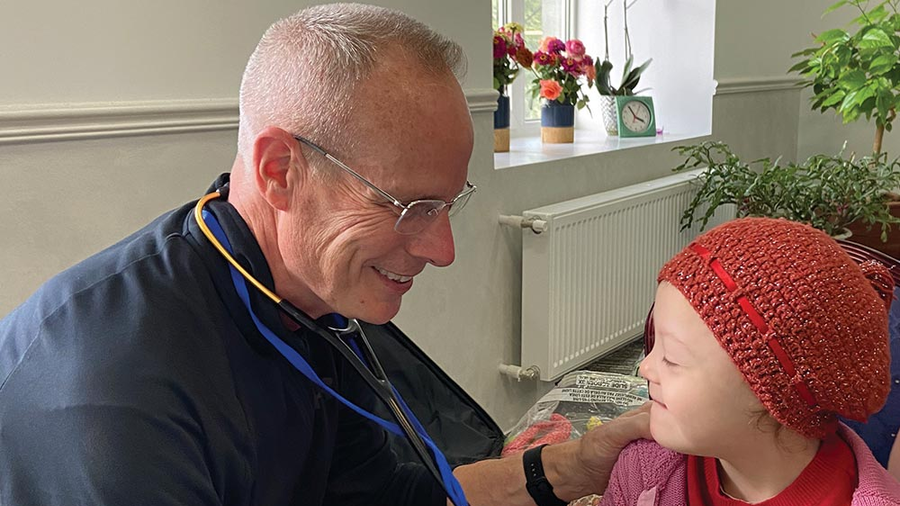 Dr. James O’Bryon, a member of Father Raymond F. Dugan Council 935 in Reynoldsville, Pa., treats a young Ukrainian refugee in Moldova during a medical mission trip in September 2022.