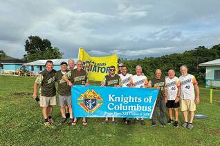 Members of Pope Pius XII Council 5295 in Narragansett, R.I., stand in front of homes for adults with disabilities that they helped to renovate last year for Jacob’s Ladder in Jamaica. Council 5295 received the International Program Award in the community category for its work with Jacob’s Ladder.