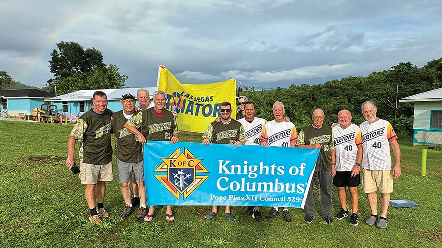 Members of Pope Pius XII Council 5295 in Narragansett, R.I., stand in front of homes for adults with disabilities that they helped to renovate last year for Jacob’s Ladder in Jamaica. Council 5295 received the International Program Award in the community category for its work with Jacob’s Ladder.