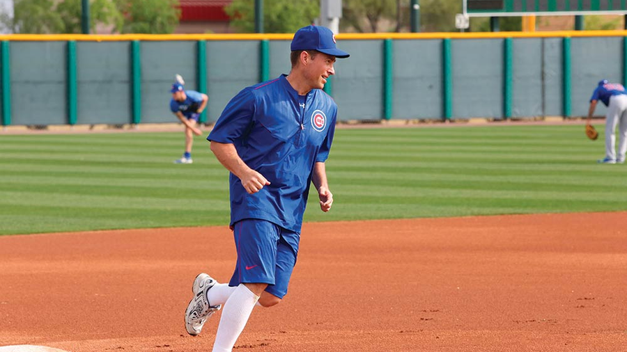 Father Burke Masters, chaplain of the Chicago Cubs, rounds third base during a workout with the team at their spring training complex in Mesa, Ariz., in March 2016. (Photo by Edward Maillard)