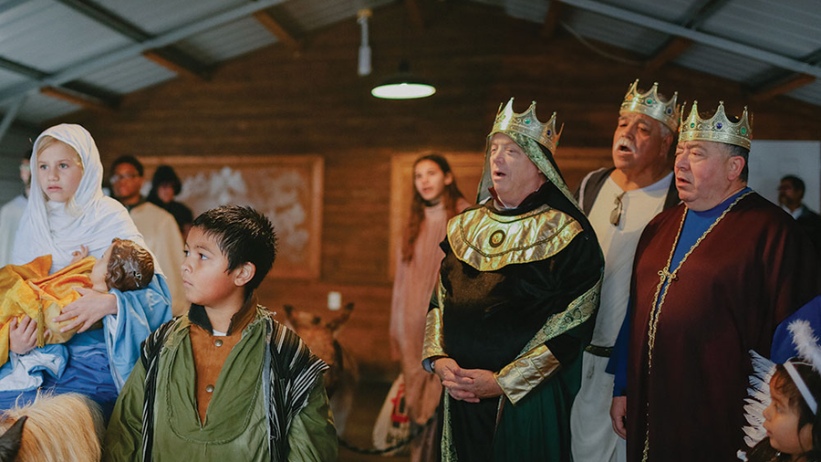 Knights and family members representing the Holy Family and the Magi sing Christmas carols during a Posada celebration at a homeless encampment in Austin, Texas. Deacons Tim Daheim, Juan de Dios Villarreal and Jesus Guerra (left to right) played the role of the Three Wise Men.