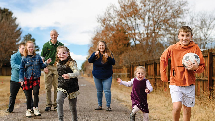 Jeff and Sonia McGarrity take a stroll with five of their eight children outside their home near Lone Tree, Colo. (Photo by Ryan Dearth)
