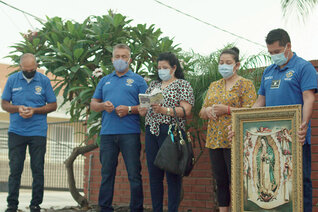 Knights and family members of St. Joseph Council 15002 in Hawthorne, Calif., pray the rosary outside a local fire station with an image of Our Lady of Guadalupe.