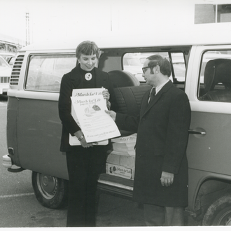 March for Life President Nellie Gray display the Life Principles, 1977, while standing at an open door of a Volkswagon bus.