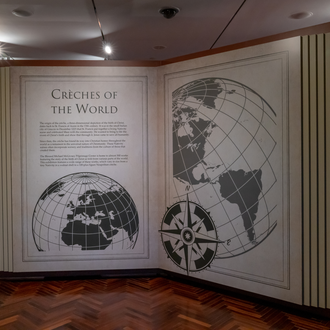 Photo of exhibit gallery featuring text panels on temporary walls that appears like large books. 