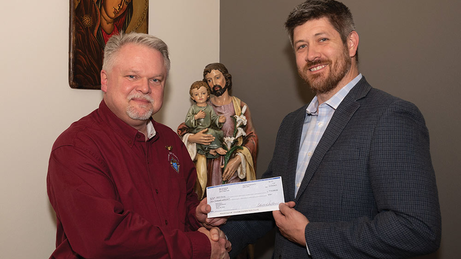 Texas State Life Director Tom Clark delivers a check for $30,000 to Aaron Fowler, Birth Choice’s executive director