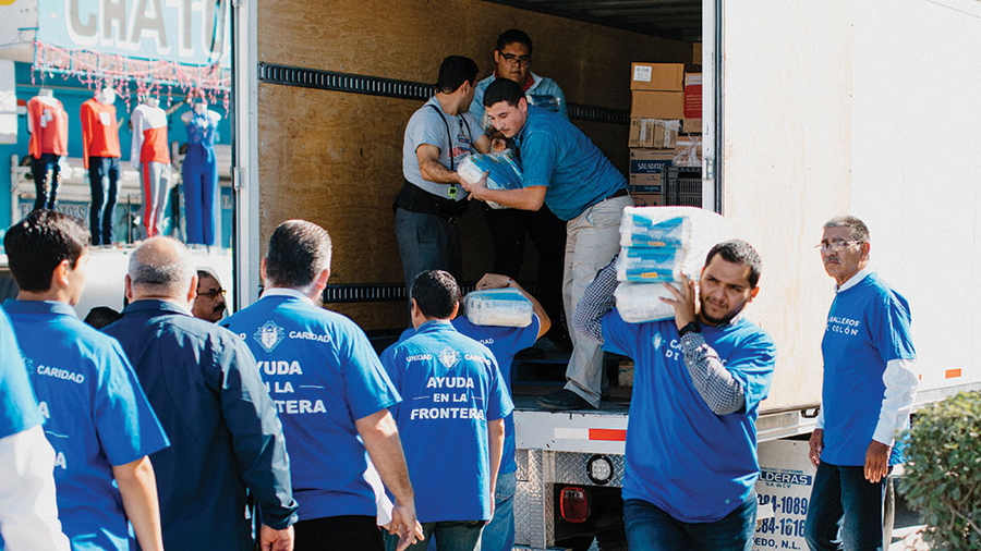 Knights unload food and supplies for the migrant families at the Casa del Migrante in Matamoros, Mexico, Dec. 13.