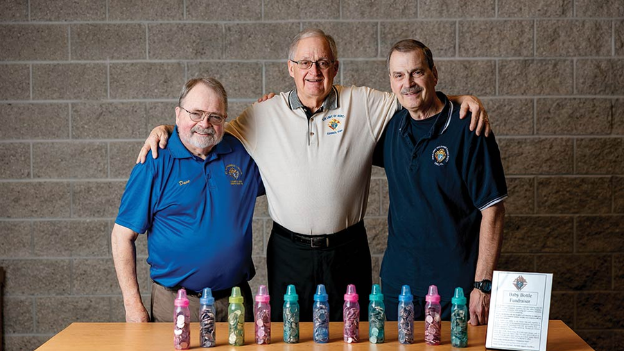From left, Dave Spacht, Phil Legler and Greg Penco stand with just a few of the thousands of baby bottles that Knights in the area used to collect $109,000 for a mobile ultrasound unit.